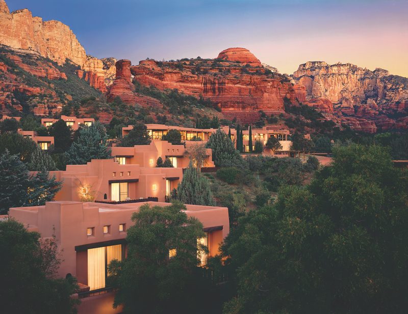 Gorgeous exterior of Enchantment Resort in Sedona Arizona with the red rocks in the distance.
