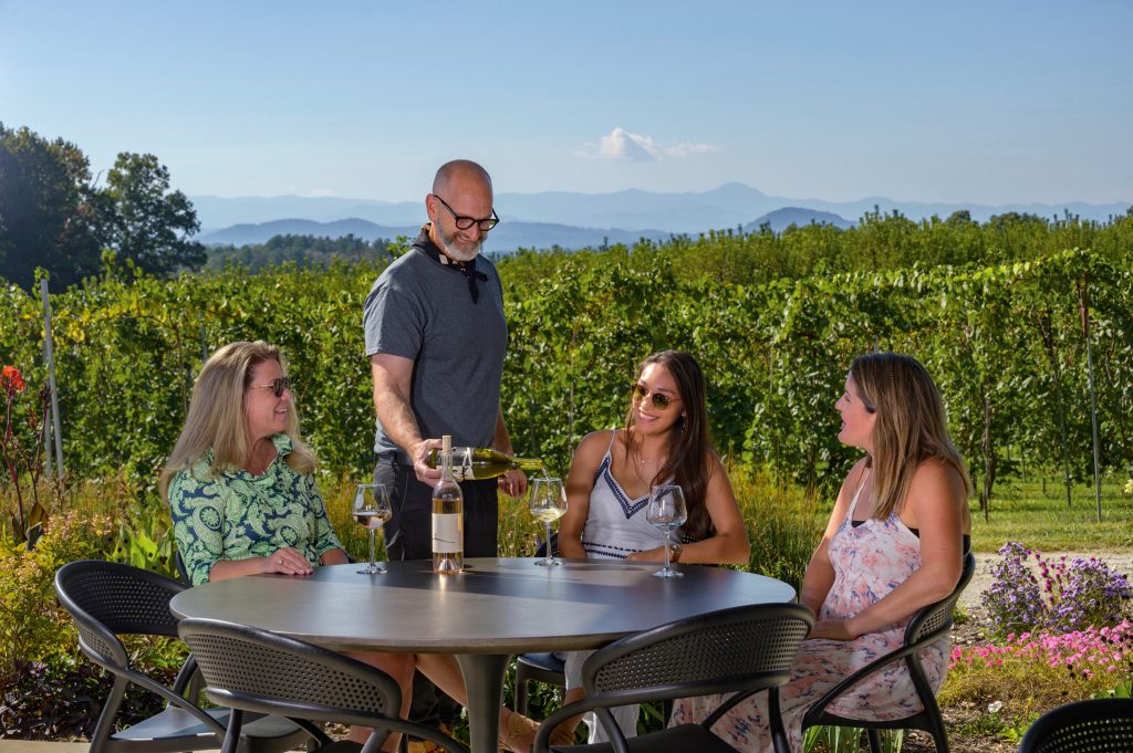 A group takes in the wine and views at a vineyard in Hendersonville, NC