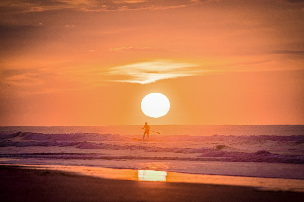 Sunrise and a paddle boarder on Isle Of Palms