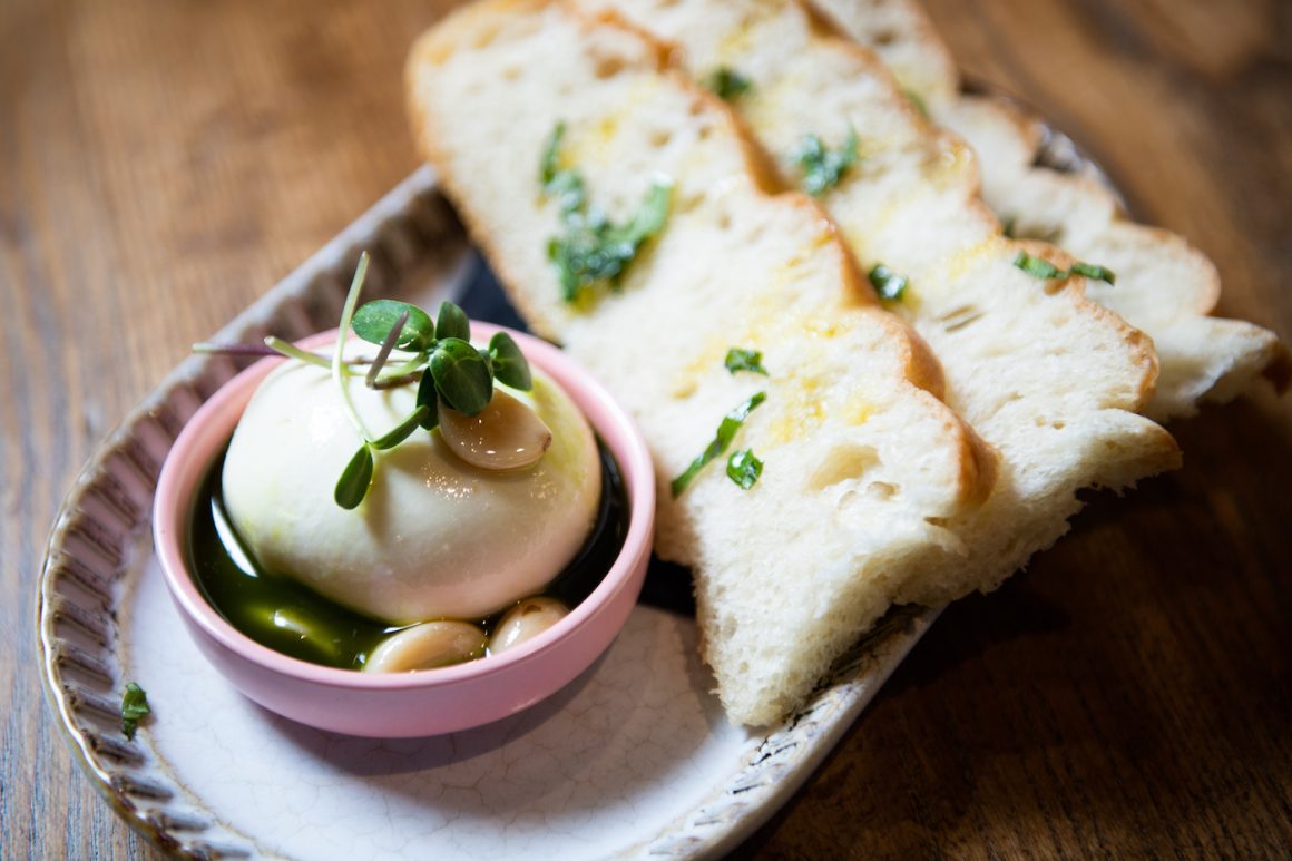 small bowl of burrata with bread wedges