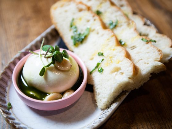 small bowl of burrata with bread wedges