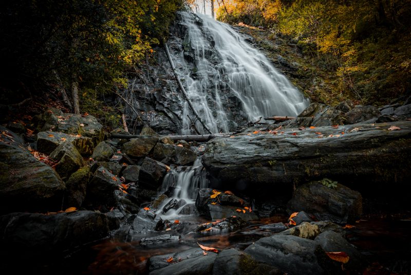 a waterfall spilling over rocks is one of the hidden gems in North Carolina