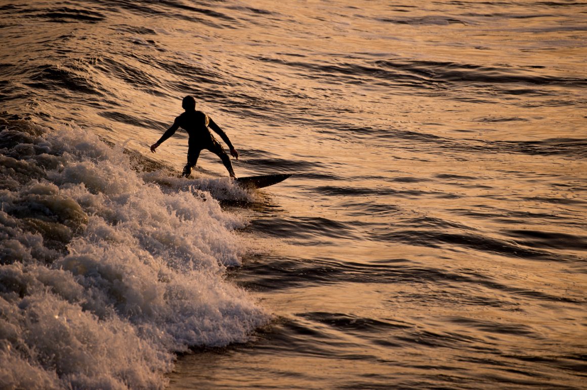 a surfer at one of the secret beaches of the Carolinas