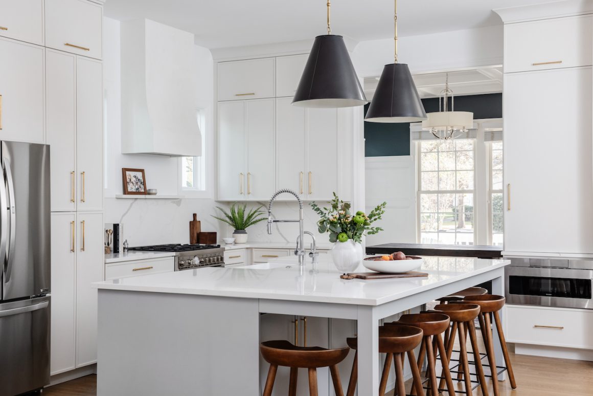 kitchen island with black pendant lights mounted above