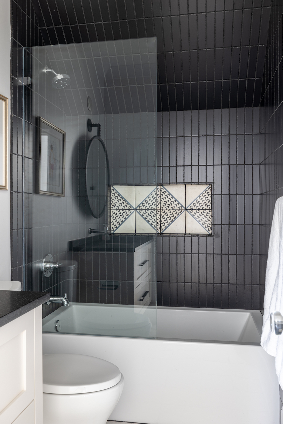 darkly tiled shower area by jones and hedges