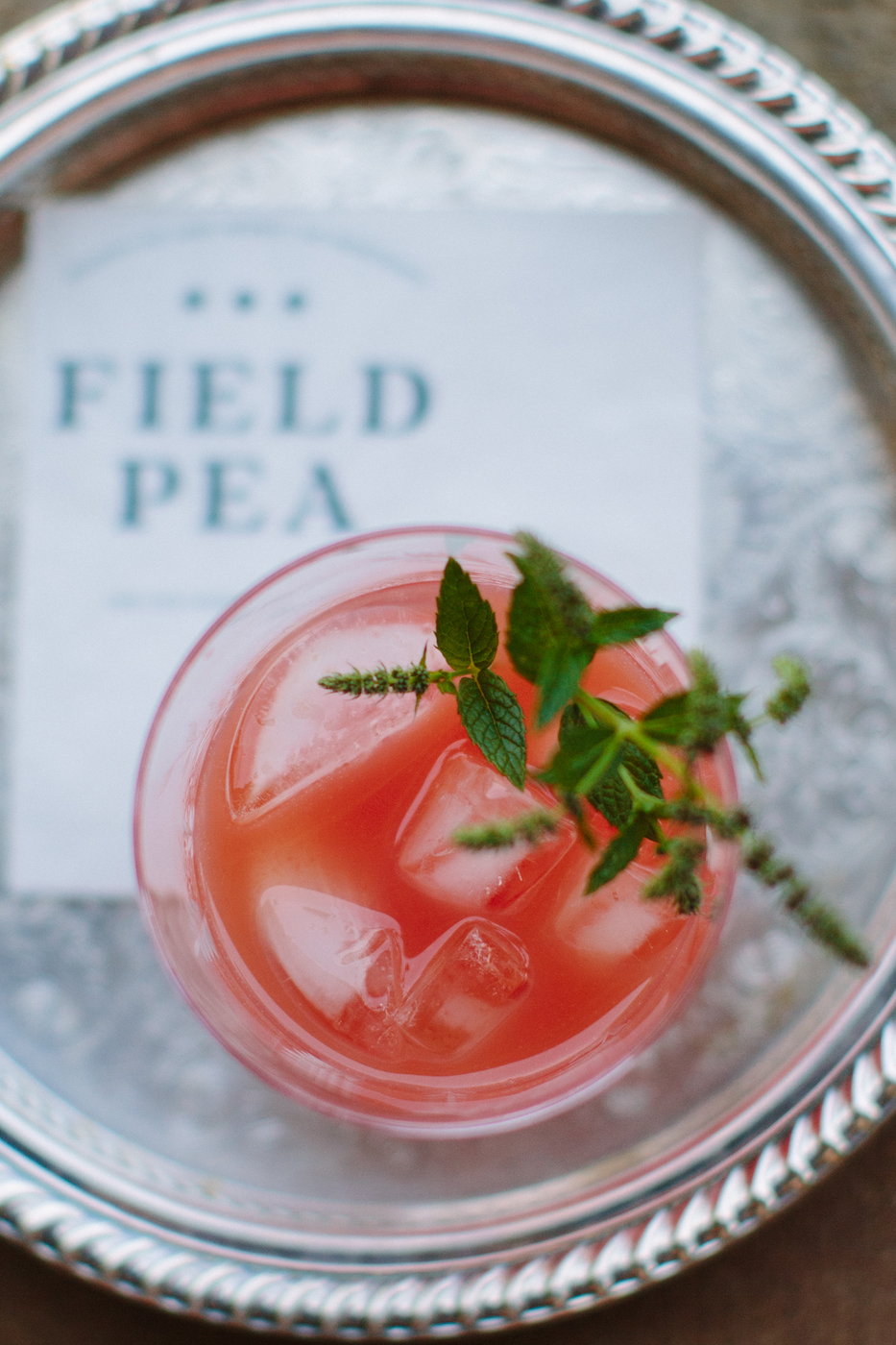 iced pink drink on a tray engraved with field pea