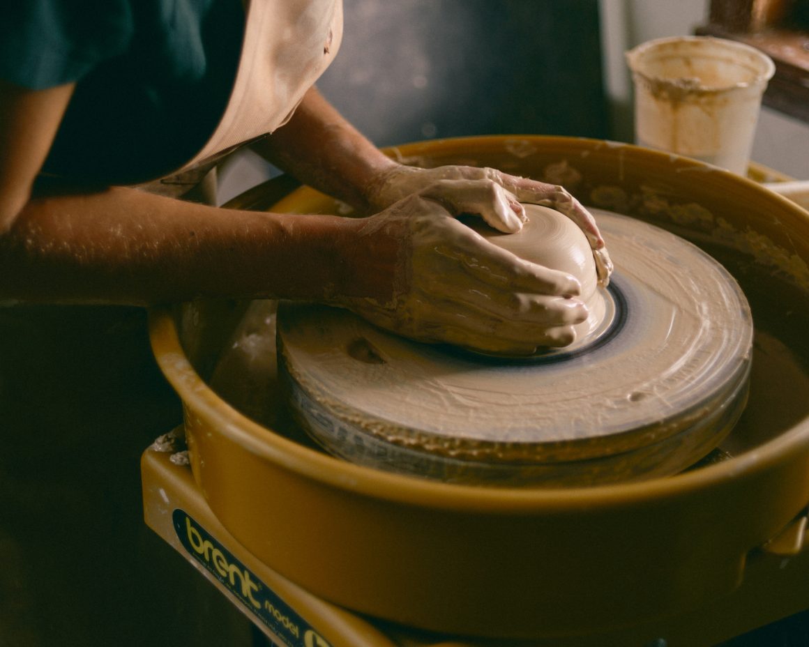 hands and clay on a pottery wheel