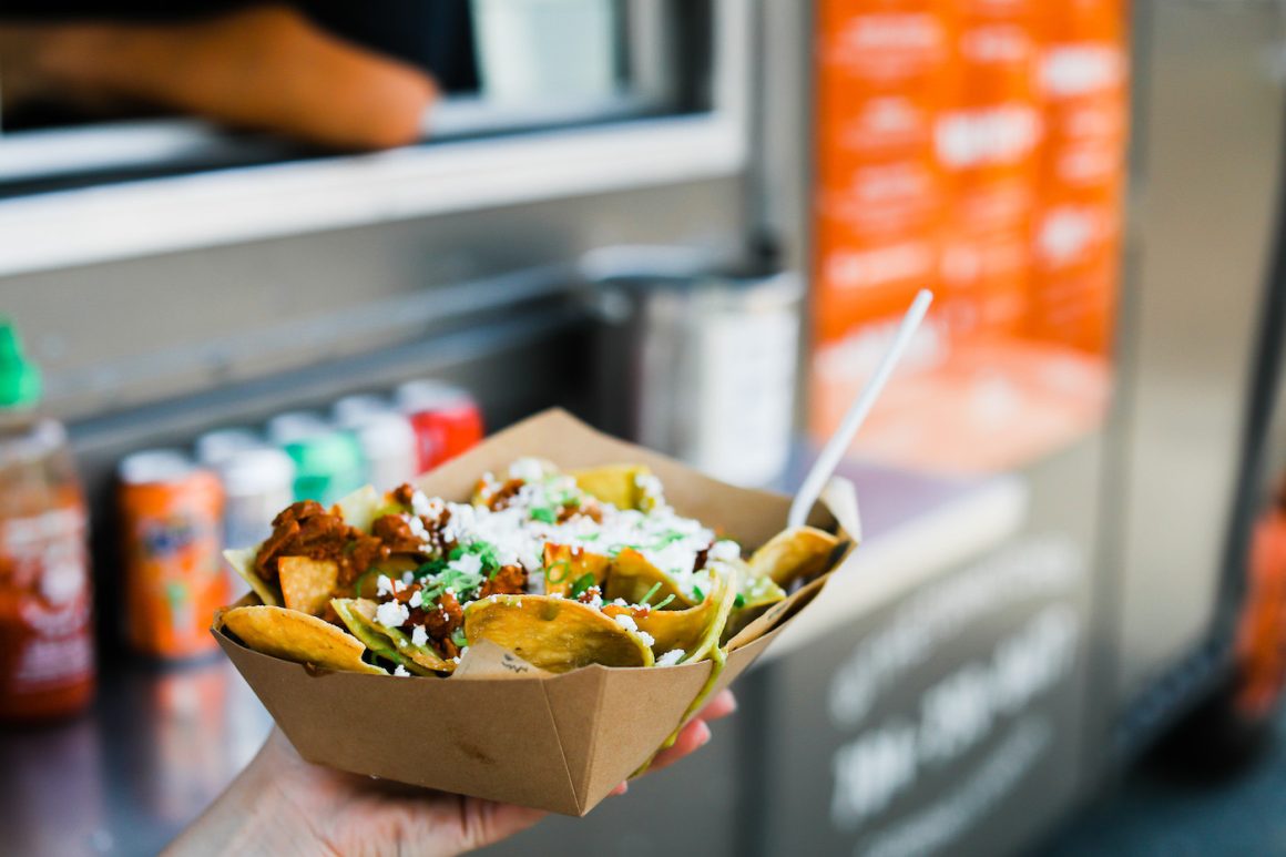 nachos held in front of tin kitchen food truck in charlotte nc