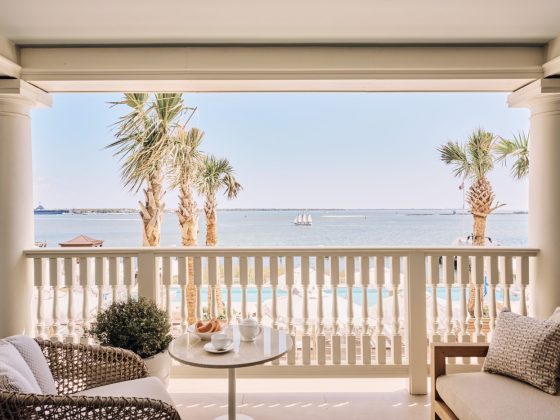 room doors open onto a porch overlooking the harbor