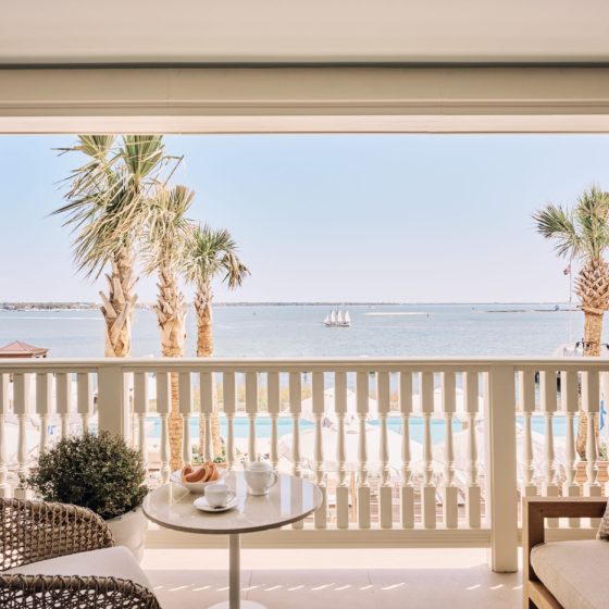 room doors open onto a porch overlooking the harbor
