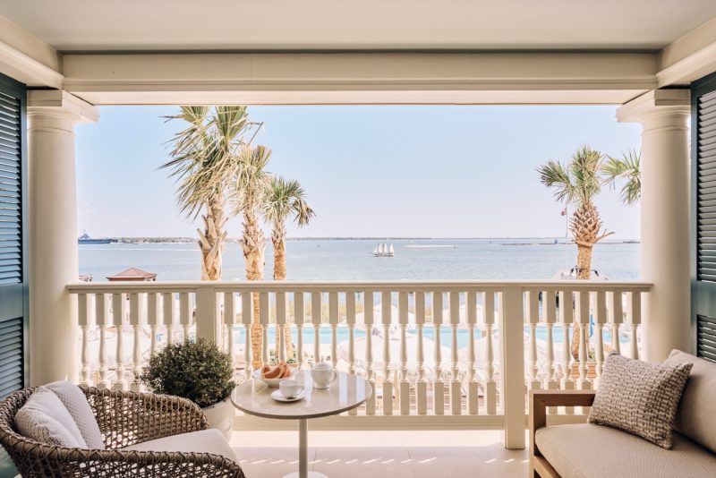 room doors open onto a porch overlooking the harbor