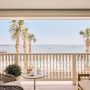 room doors open onto a porch overlooking the harbor